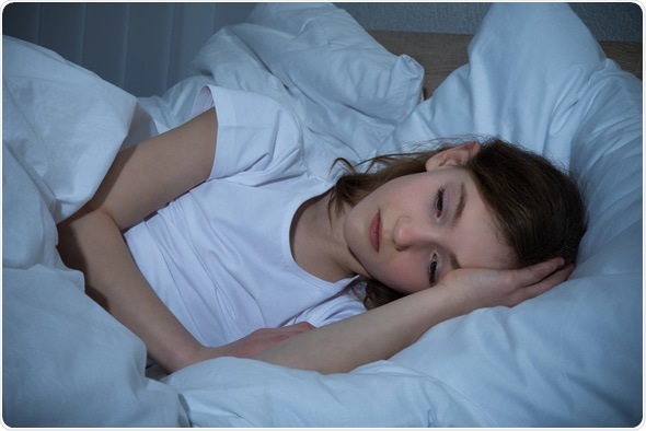 Girl In Bedroom Having Sleeplessness Night - Image Copyright: Andrey_Popov / Shutterstock