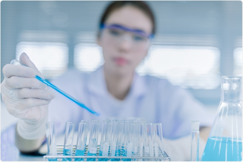 Scientist studying DNA in test tubes