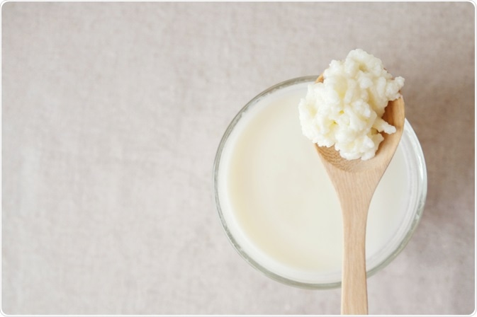 Kefir grains next to glass of kefir milk - by SewCream