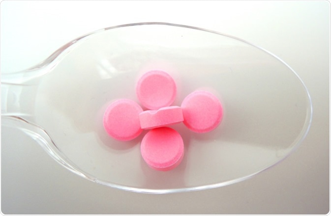 A spoon with tablets of warfarin sodium. Warfarin is a Vitamin K antagonist which is used for preventing the blood from clotting. Image Credit: Dajra / Shutterstock