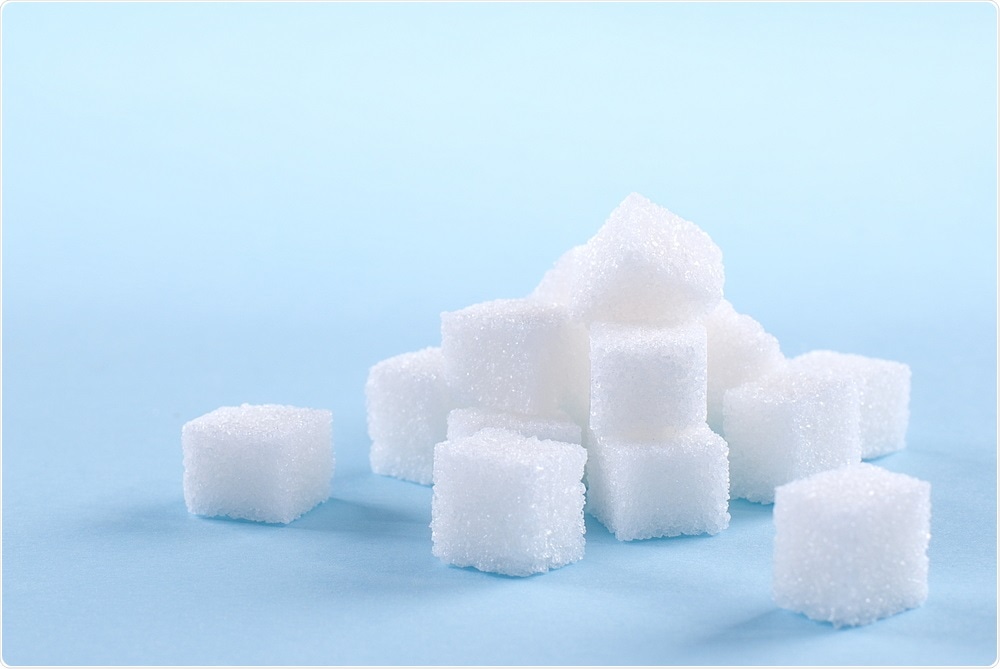 Sugar cubes on blue background
