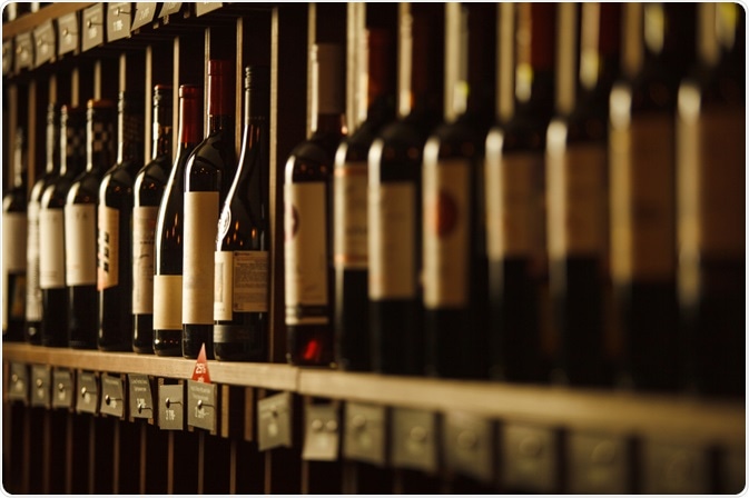 Wine bottles lined up in cellar