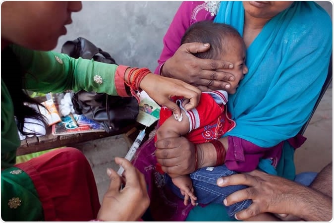 Moradabad, Uttar Pradesh, India. Measles shot administered to 11-month-old Armaan as his mother Fatima clutches him. Photo credit: UNICEF/India/Sumit Dayal