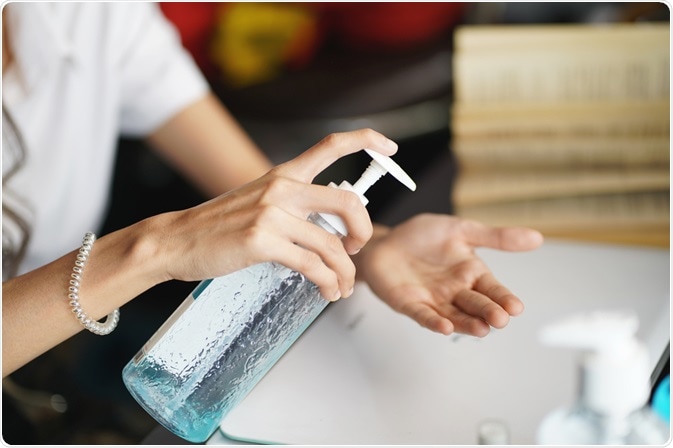 Woman using hand sanitizer