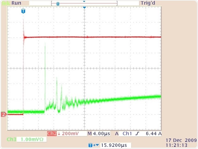The quasi-cw laser output (lower trace) and drive current waveform (upper trace) showing the relaxation oscillations at the beginning of the pulse shown in Figure 4.