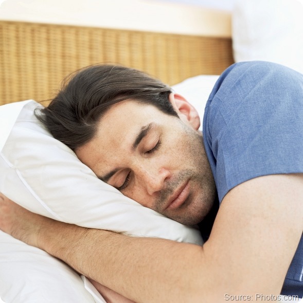 close-up of a young man sleeping on the bed