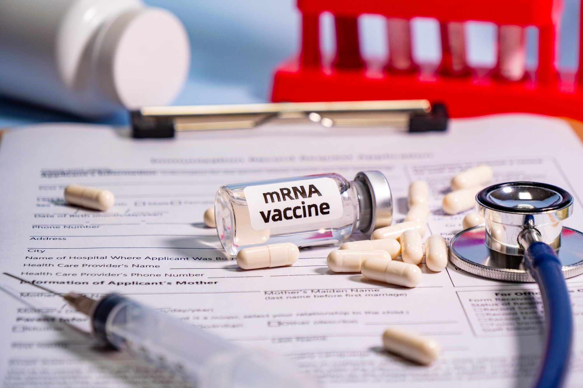 Close-up of mRNA vaccine and syringe.