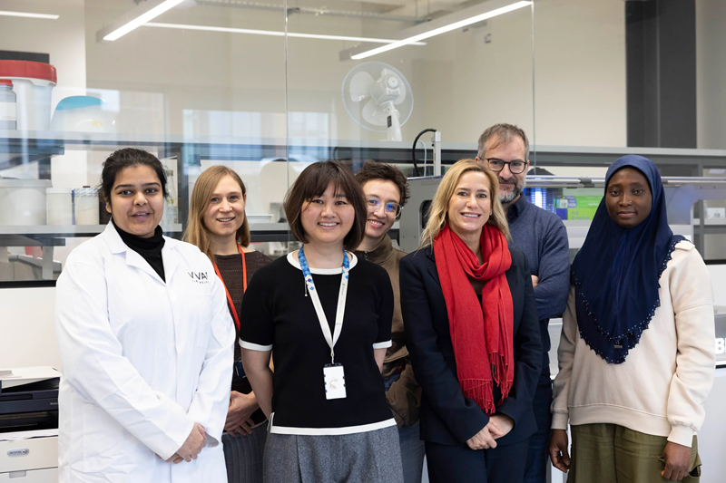 A group of scientists from Vivan Therapeutics smiling at the camera.