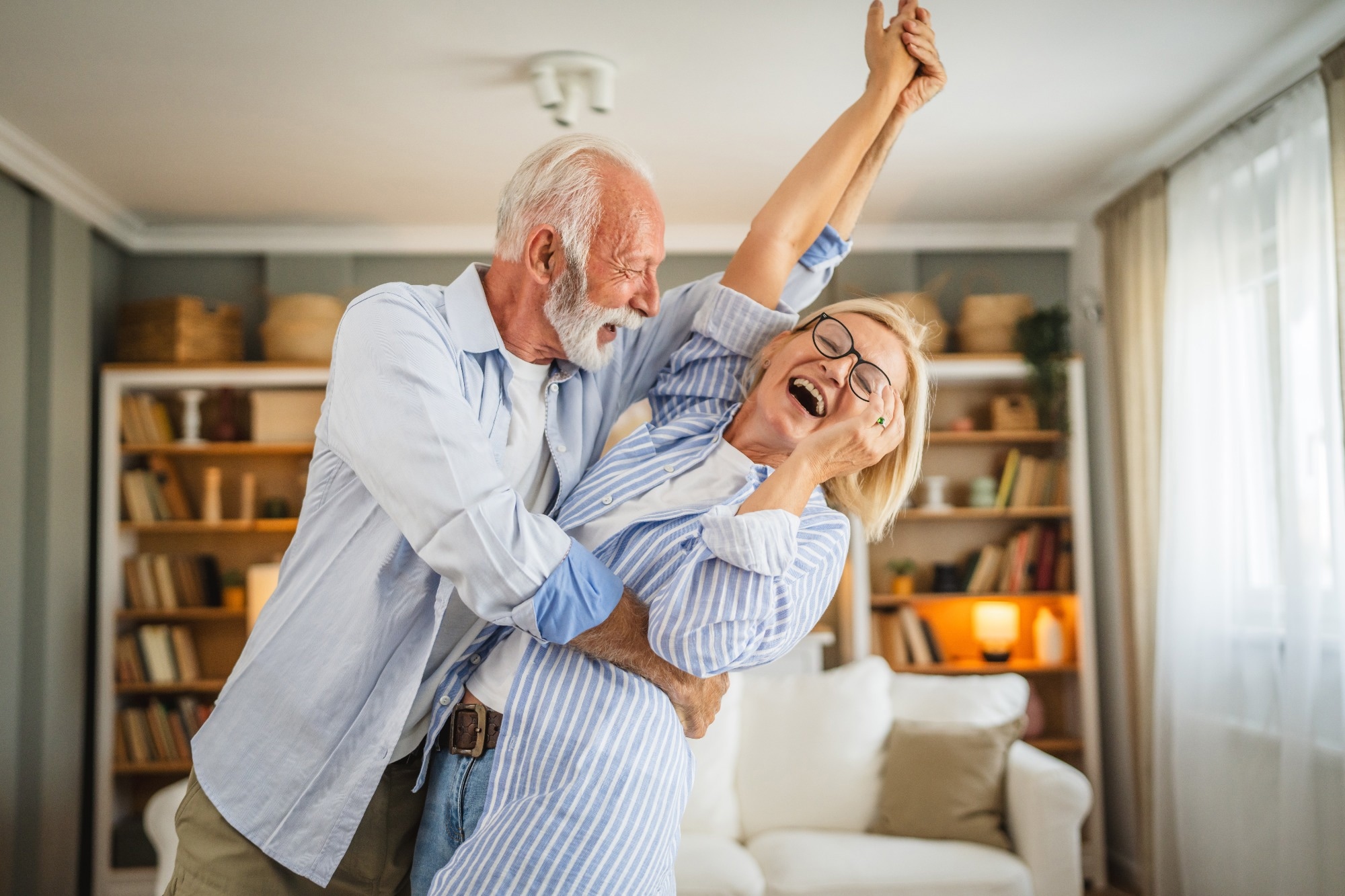 Senior active couple husband and wife dancing.