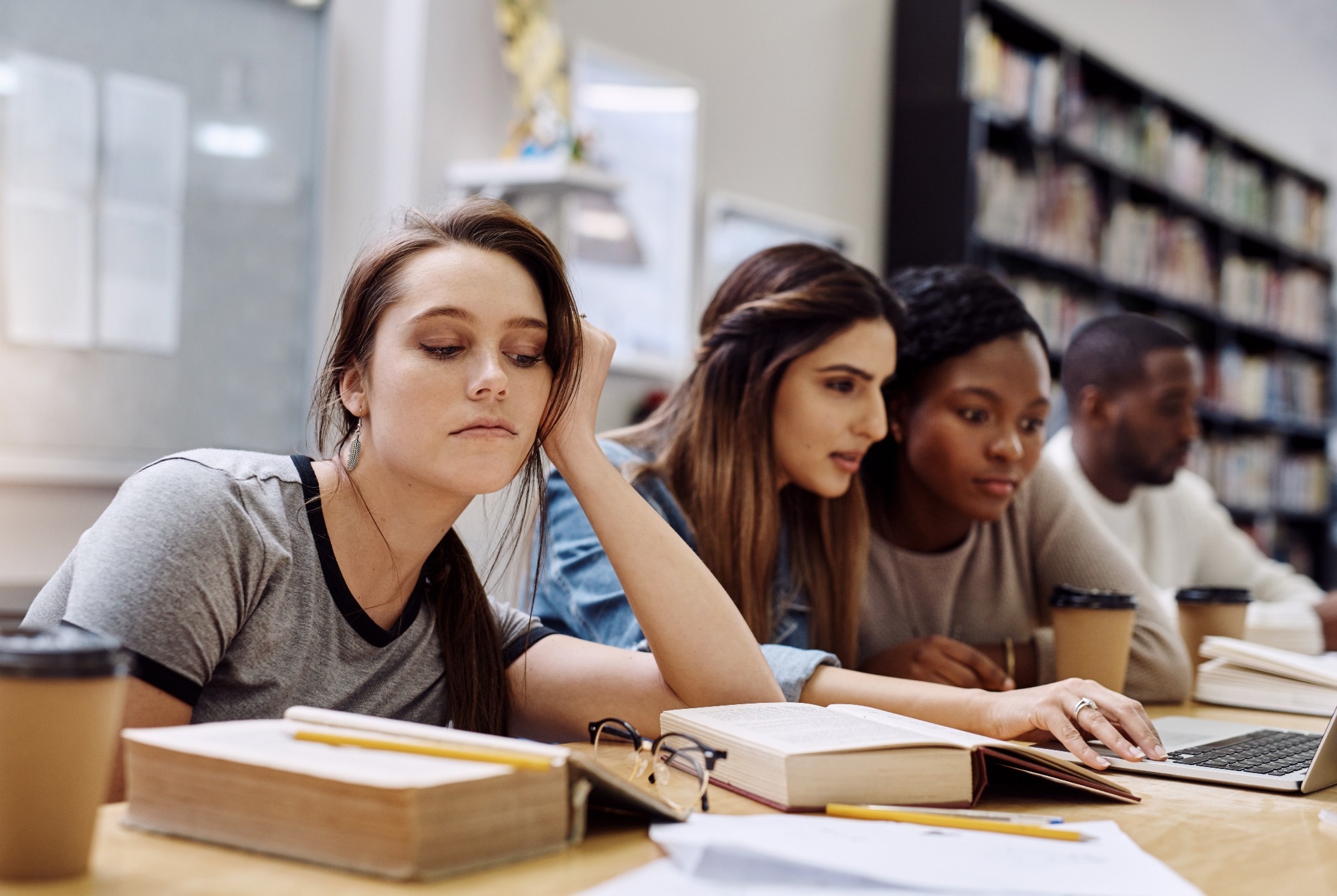 face of unhappy student with books in library