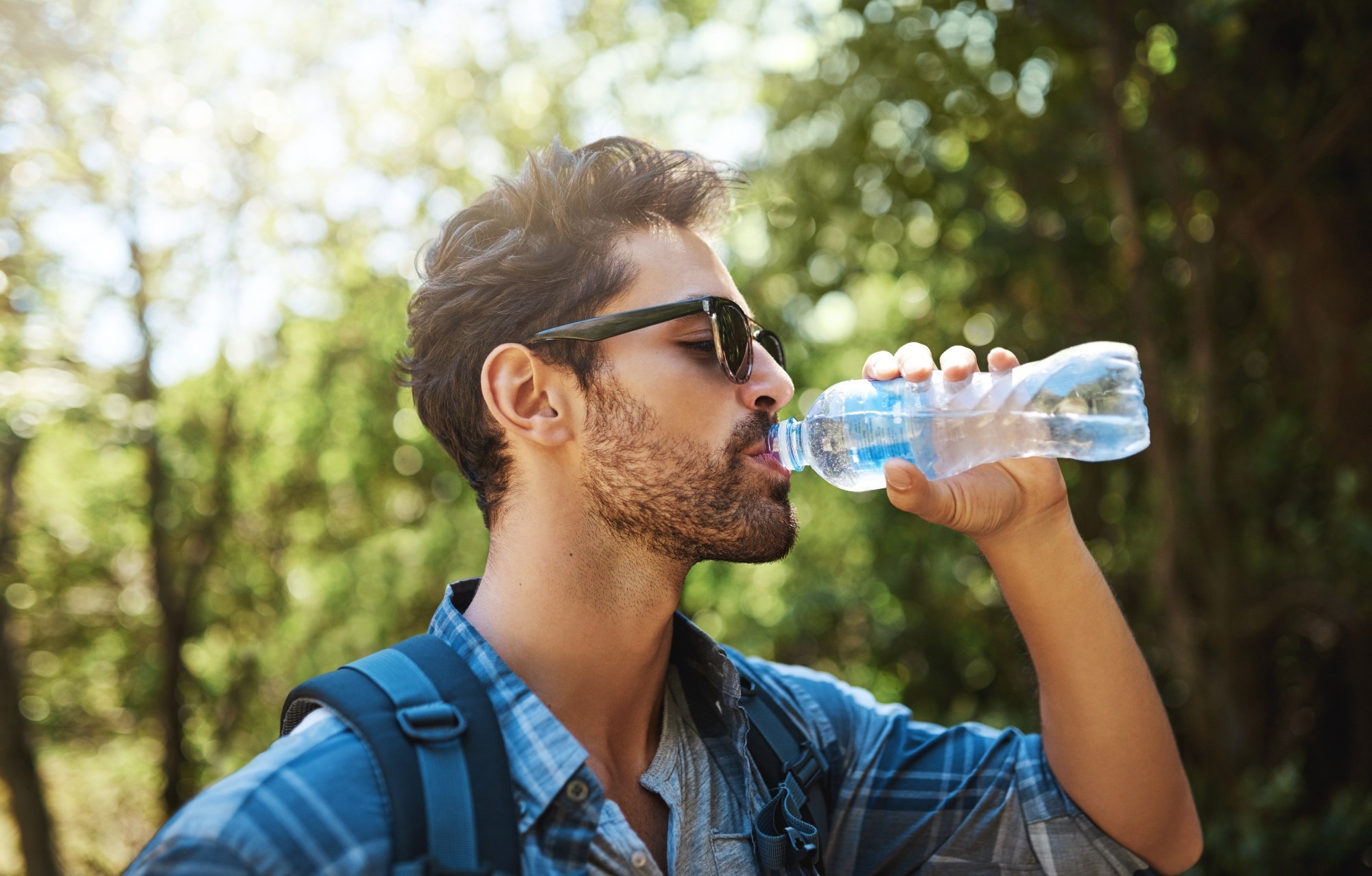 young man stopping for a drink of water