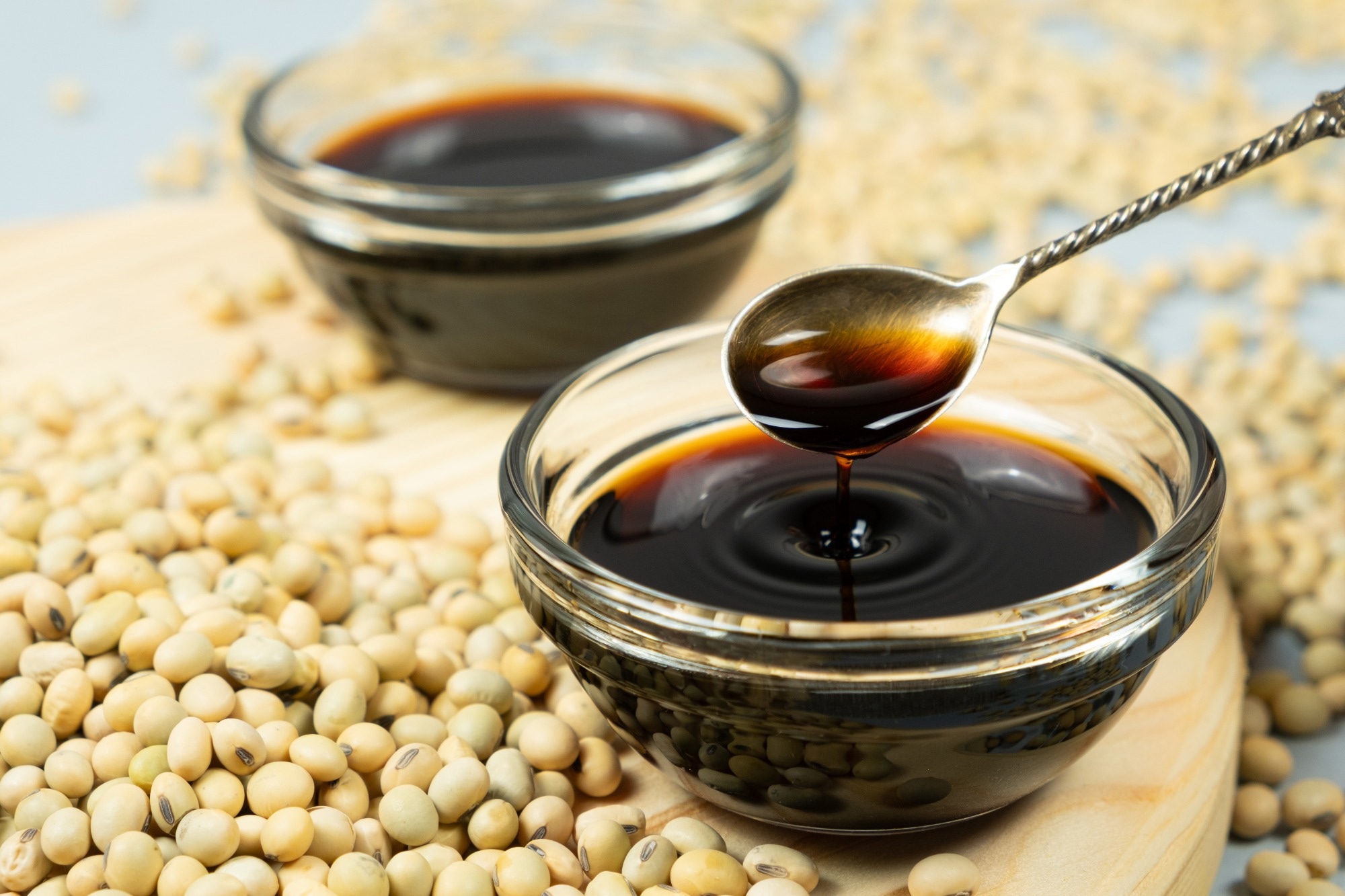 Umami-Rich Soy Sauce in Spoon Among Soybeans.
