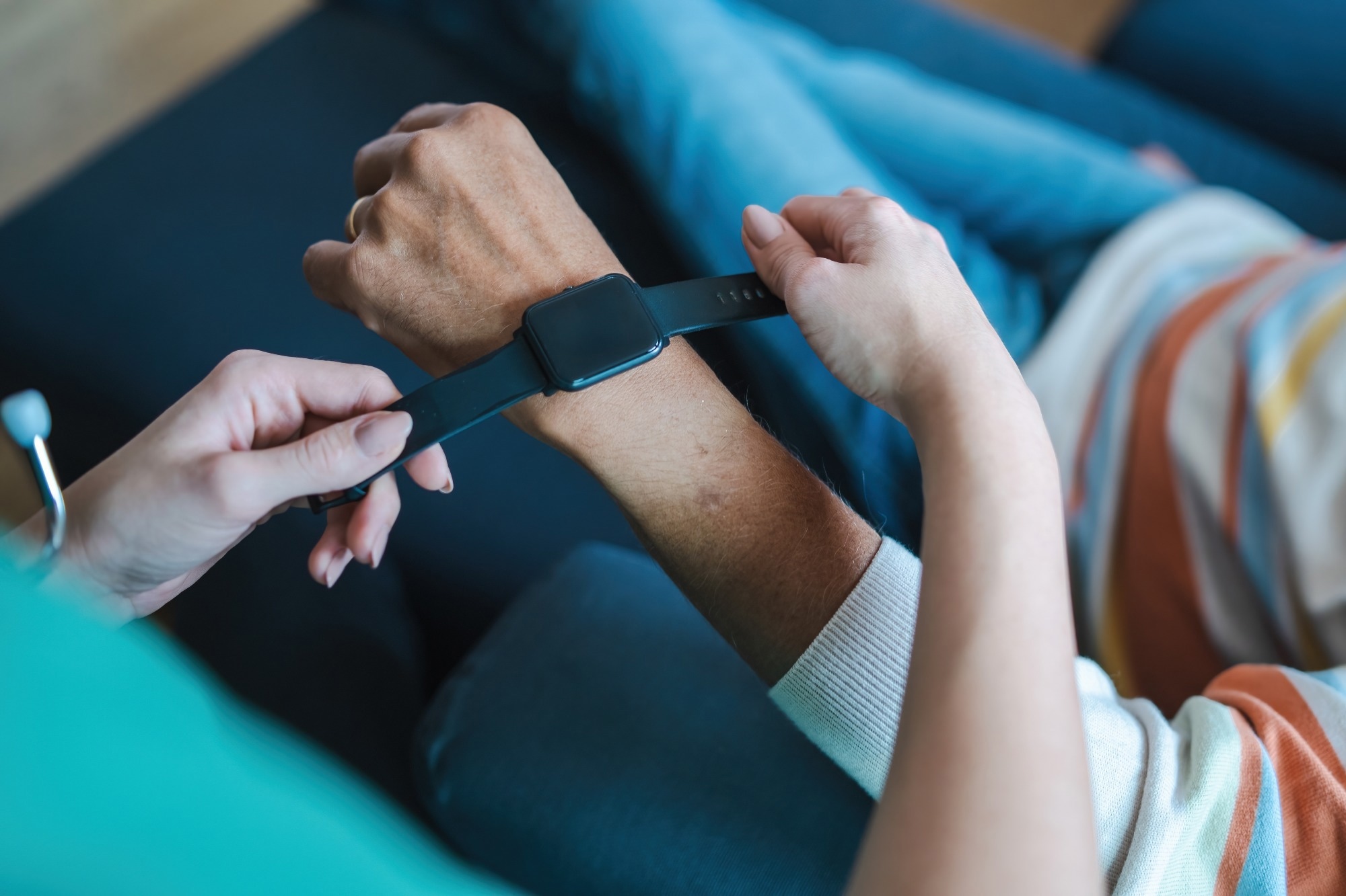 Hands adjusting a smartwatch for health monitoring